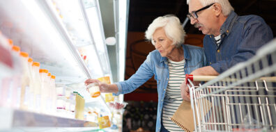 older couple looking into food and beverage chiller