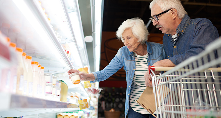 older couple looking into food and beverage chiller