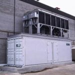 Low Temperature Containerized Refrigeration Plant with upper level condenser on a concrete pad.